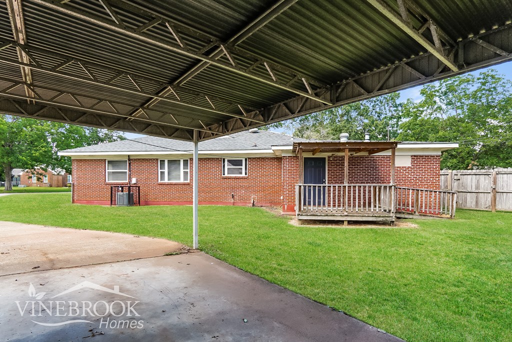 the front of a brick house with a covered porch and a garage