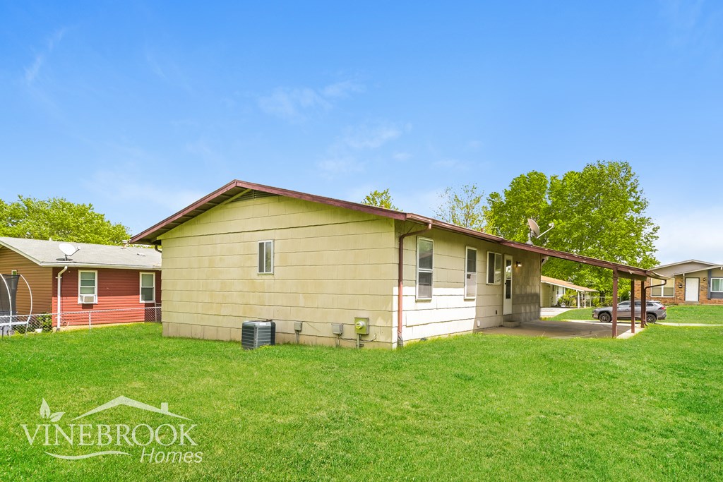 A house with a lawn in front of it and the words Vinebrook Homes on the bottom left.