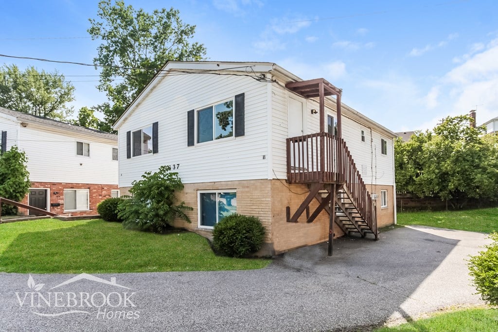 A house with a Vinebrook Homes sign in front.