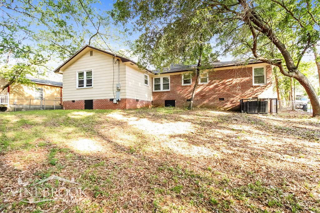 A house with a tree in front of it.