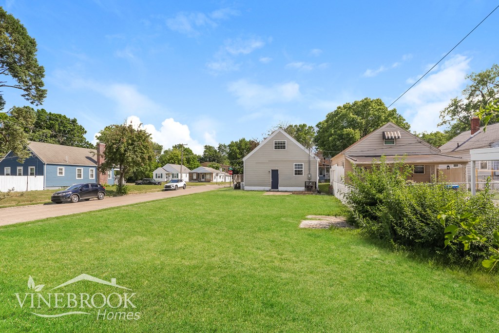 a neighborhood with houses and a green lawn