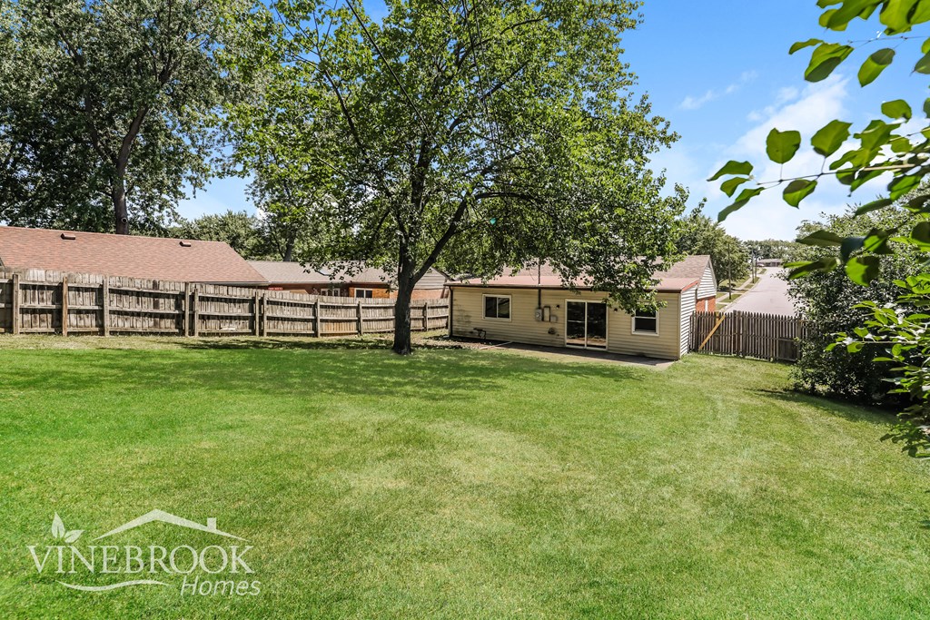 a backyard with a house and a yard and trees