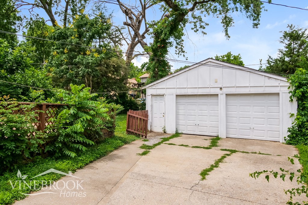 a garage with a white garage door and a driveway