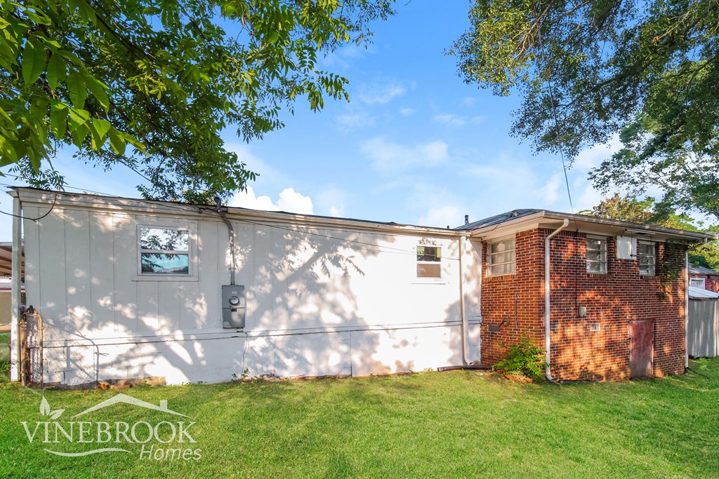 the backyard of a house with a yard and a fence