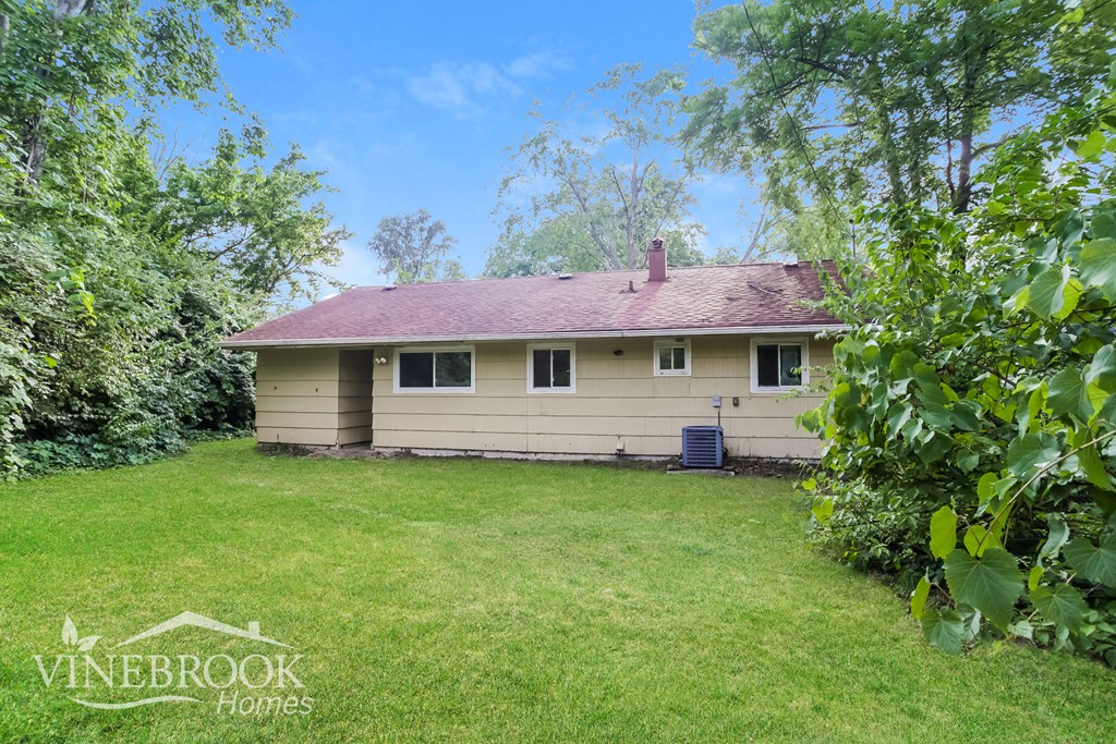 the backyard of a house with a yard and a lawn