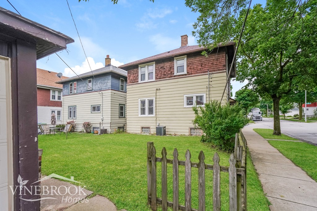 a house with a yard and a wooden fence