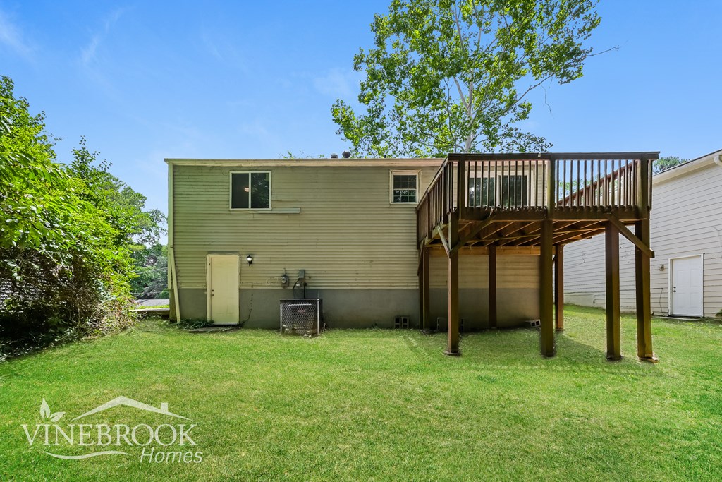 a backyard with a deck on top of a house