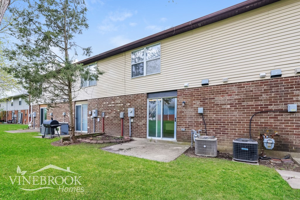 A Vinebrook Homes residential building with a green lawn in front.