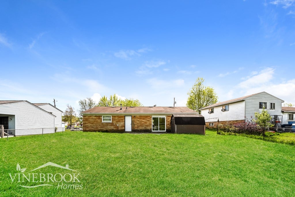 A Vinebrook Homes sign is on a grassy field.