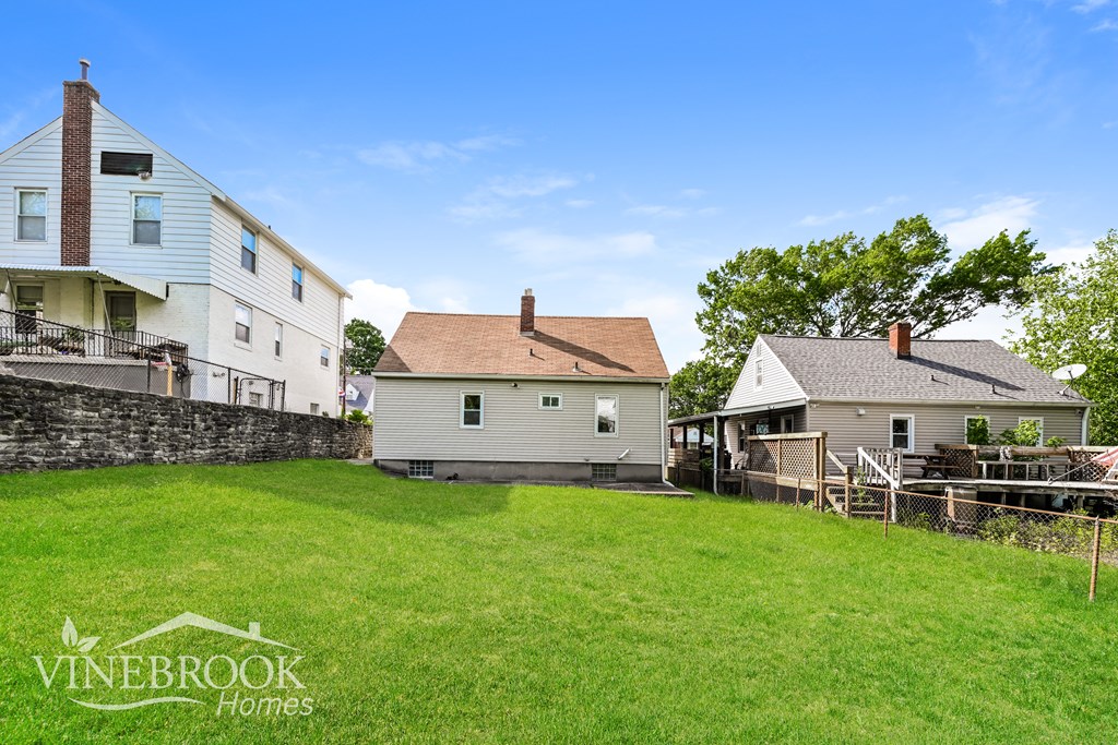 A Vinebrook Homes sign is on a grassy area in front of a house.