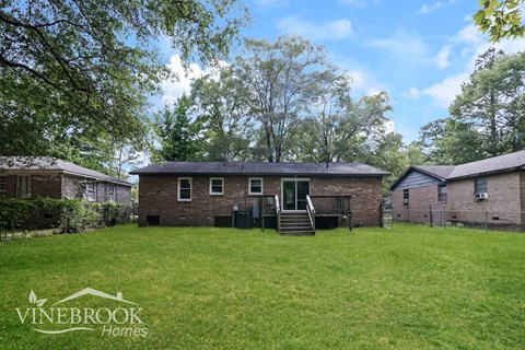 A house with a lawn in front of it and the words Vinebrook Homes on the bottom left.