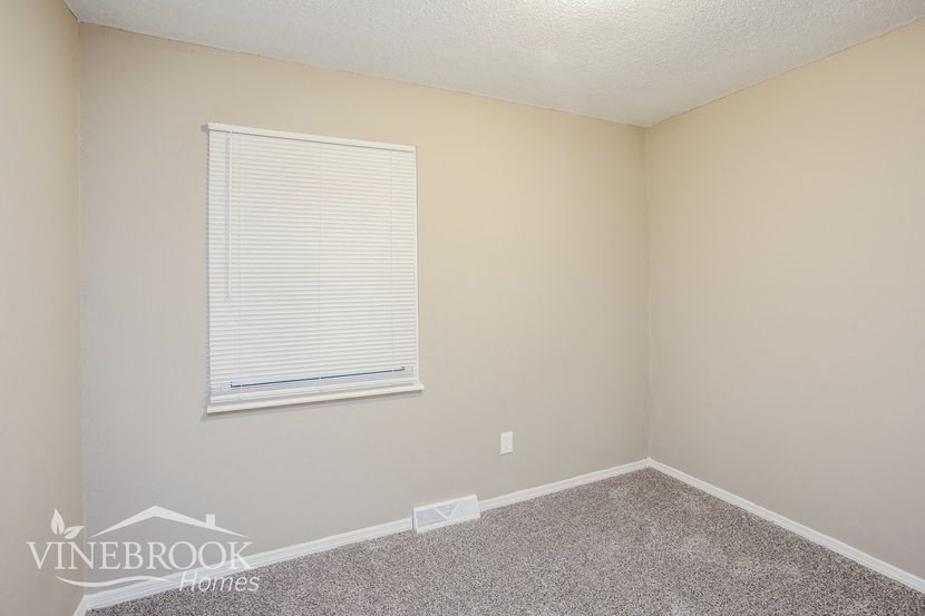 a room with a window and a carpet