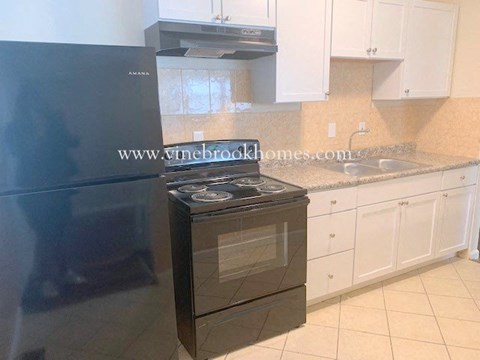 a kitchen with a stove and a refrigerator