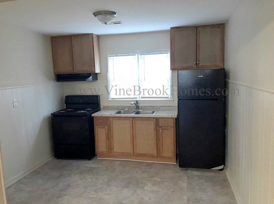 a small kitchen with a sink and a refrigerator