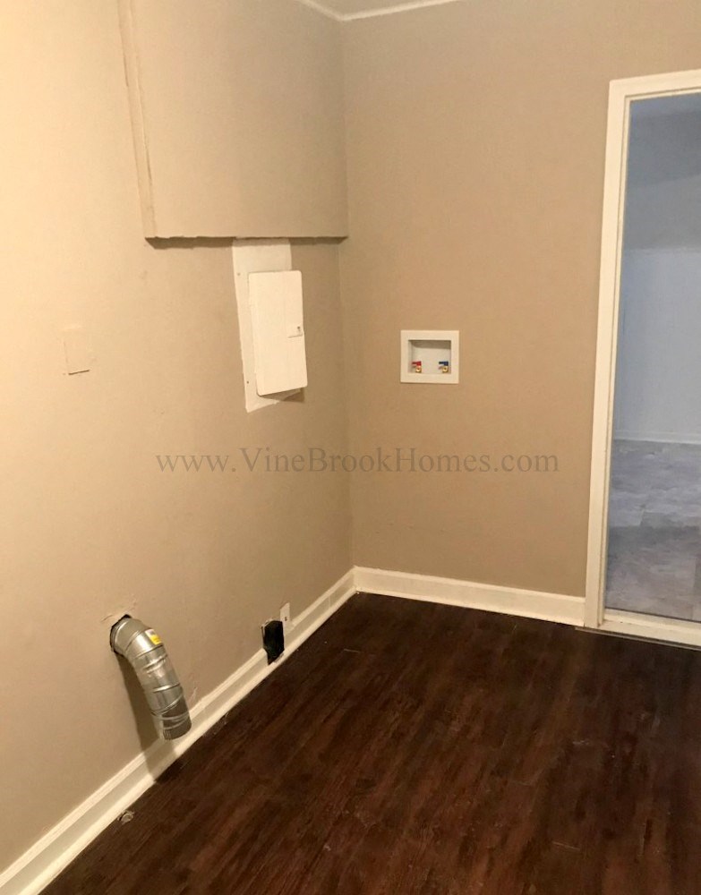 a small room with a water heater and a window