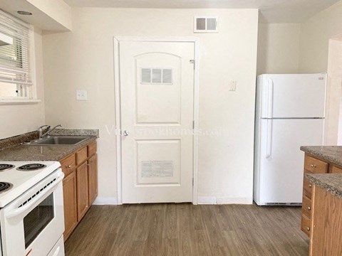 a kitchen with a stove and a refrigerator