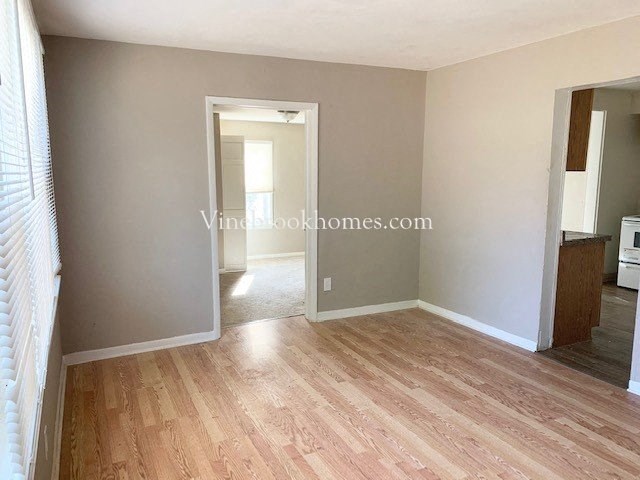 a living room with a hard wood floor and a doorway