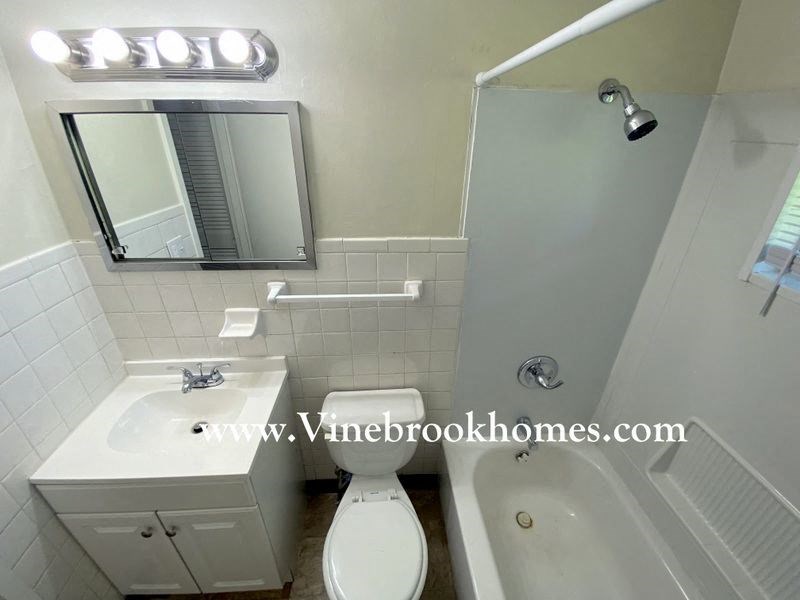 a bathroom with a toilet and a sink and a mirror