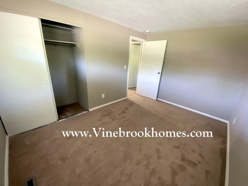 a empty living room with wooden floors and a closet