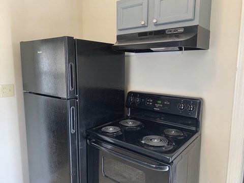 a kitchen with a stove and a refrigerator