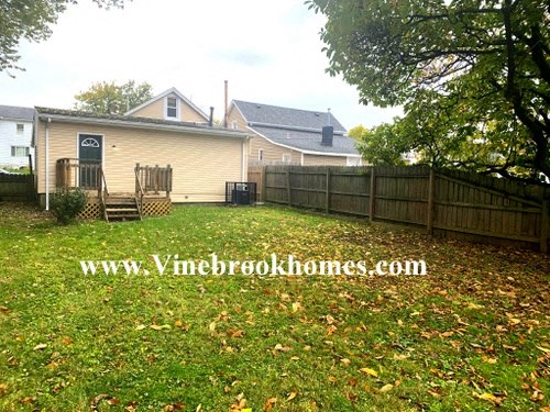 a backyard with a fence and a house