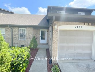 a brick house with a white garage door