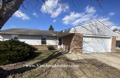 a brick house with a white garage door