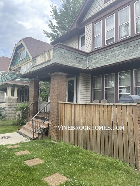 a house with a wooden fence in front of it