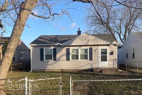a small house with a tree in front of it