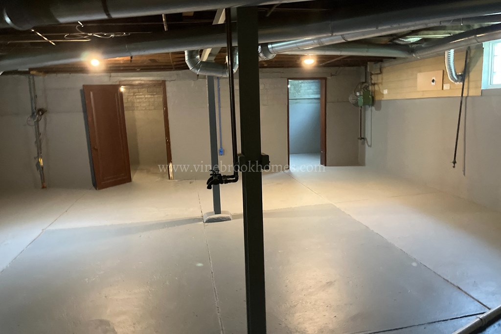 a small room with a white floor and a door in the middle