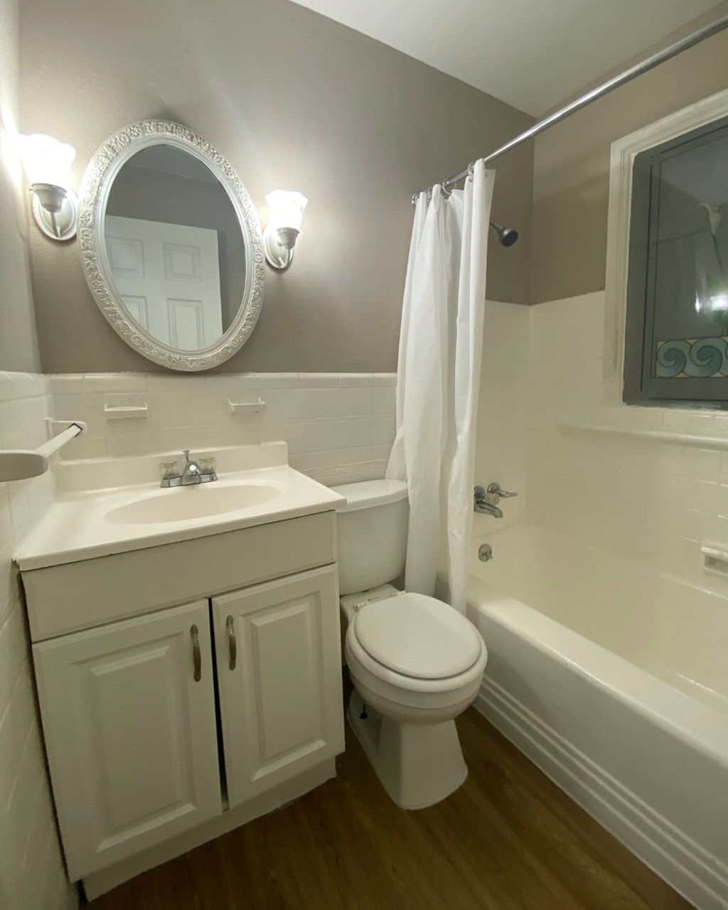 a small bathroom with a sink toilet and tub