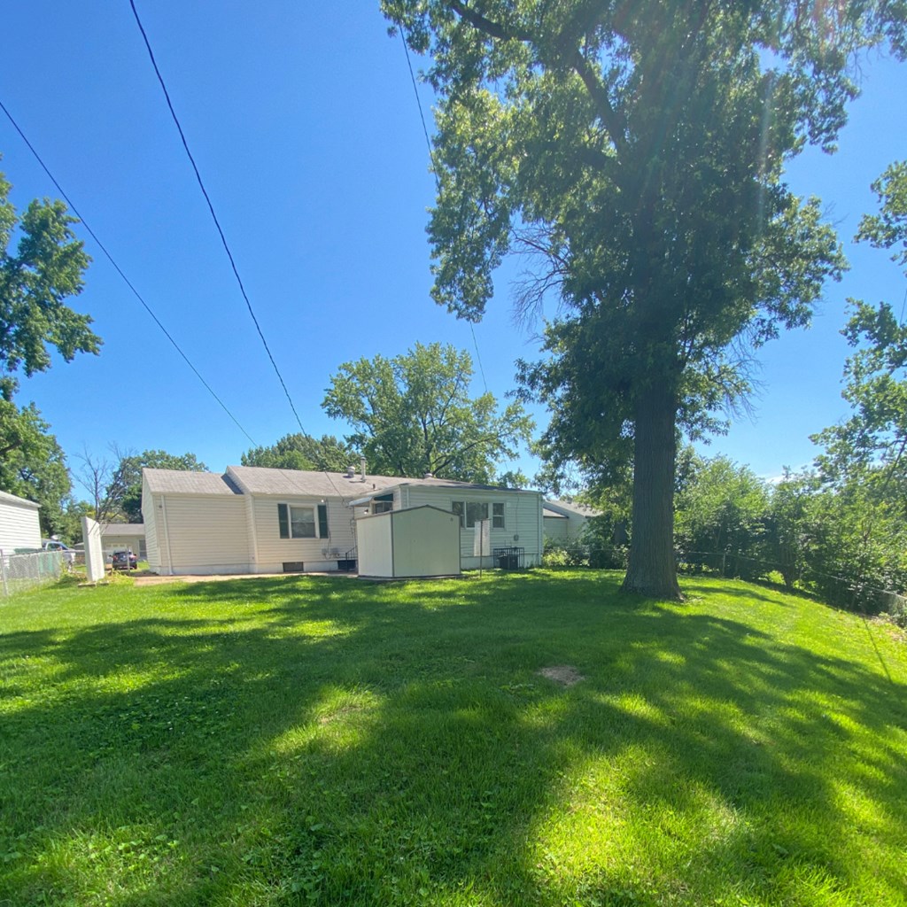 a house with a large yard and a tree