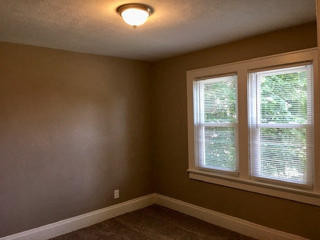 a empty room with a window and a light on the ceiling