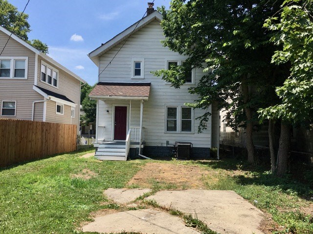 a white house with a yard in front of it