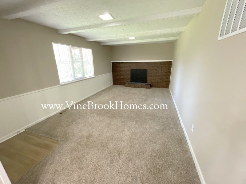 a living room with a carpet and a tv
