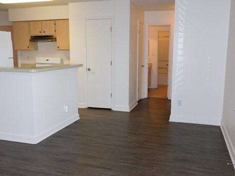 A kitchen with white cabinets and a white counter top.