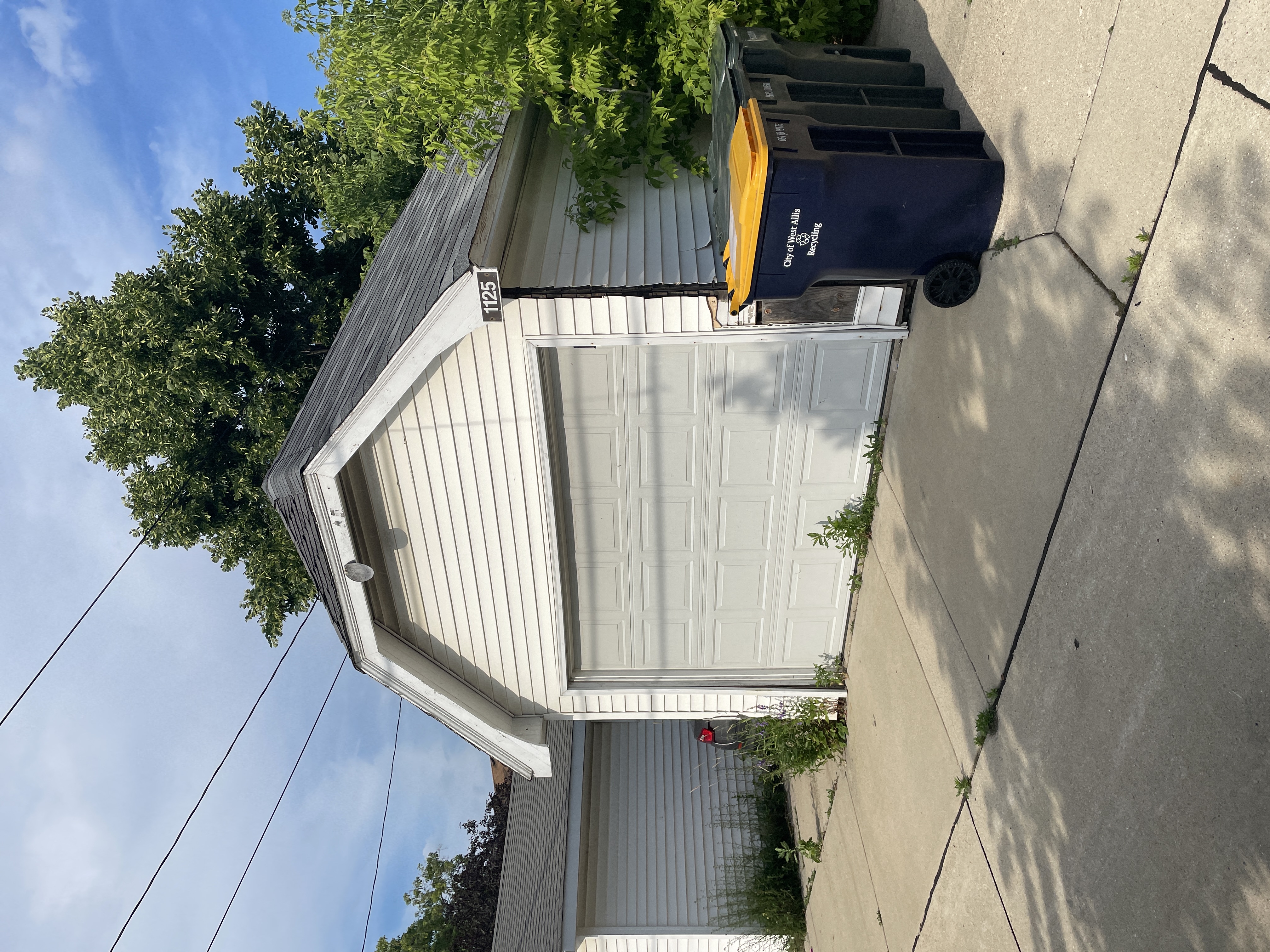 a building with a blue and white roof and a blue truck parked next to it