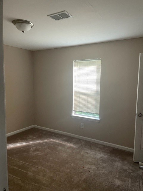 an empty room with a window and a door