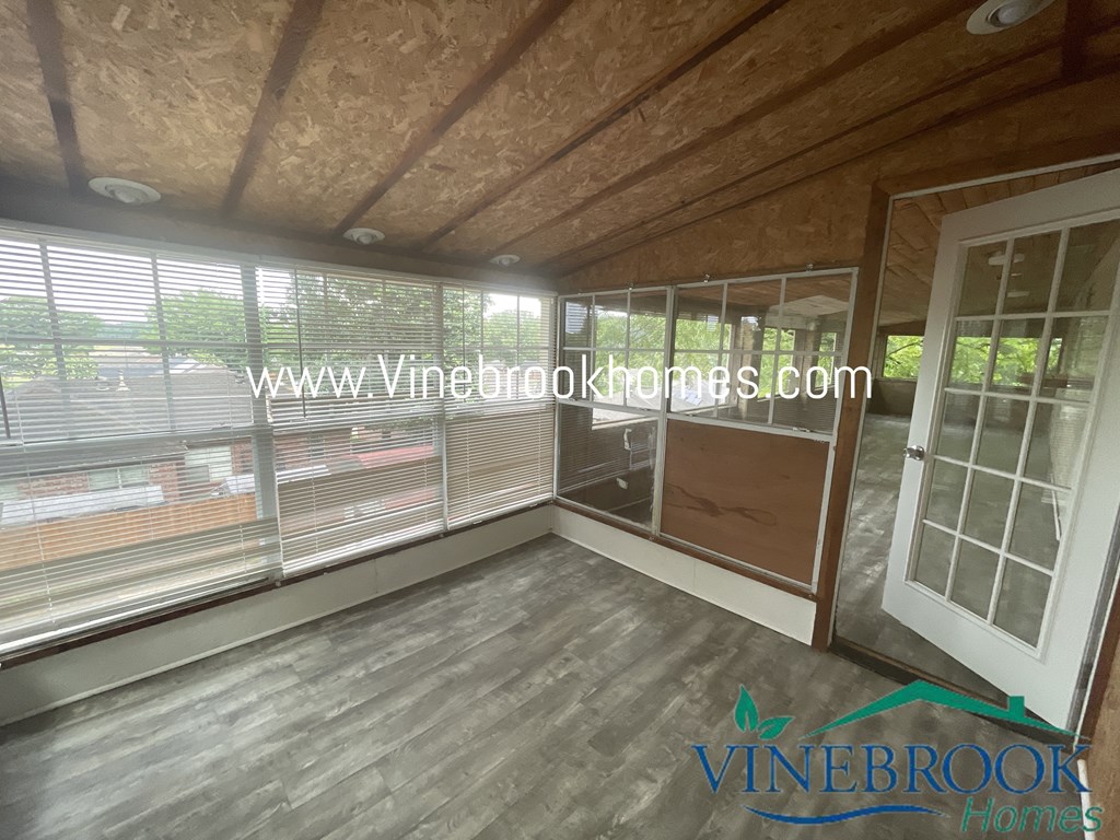 a small living room with a large window and a sliding glass door