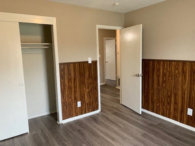 an empty room with a wood floor and a door