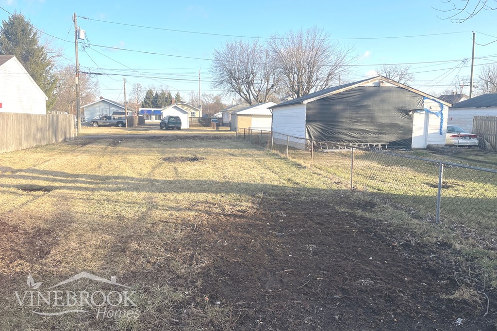 the backyard of a house with a yard and a fence