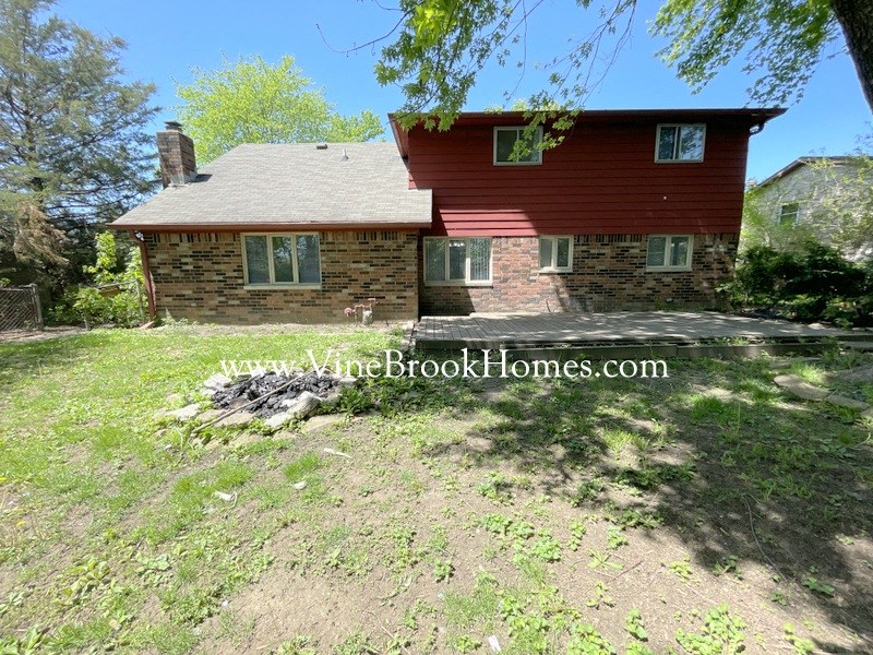 a brick house with a yard in front of it