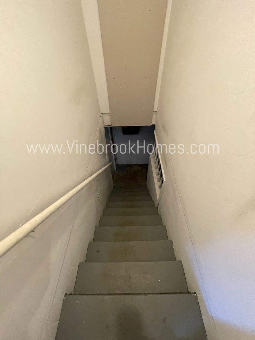 a flight of stairs going down a tunnel