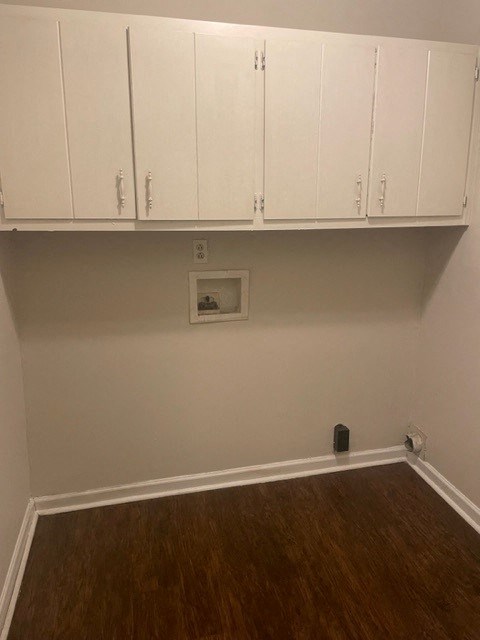 an empty room with white cabinets on the wall