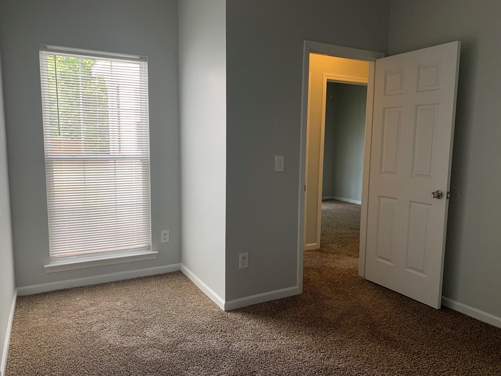 a room with a door and a window and a hallway
