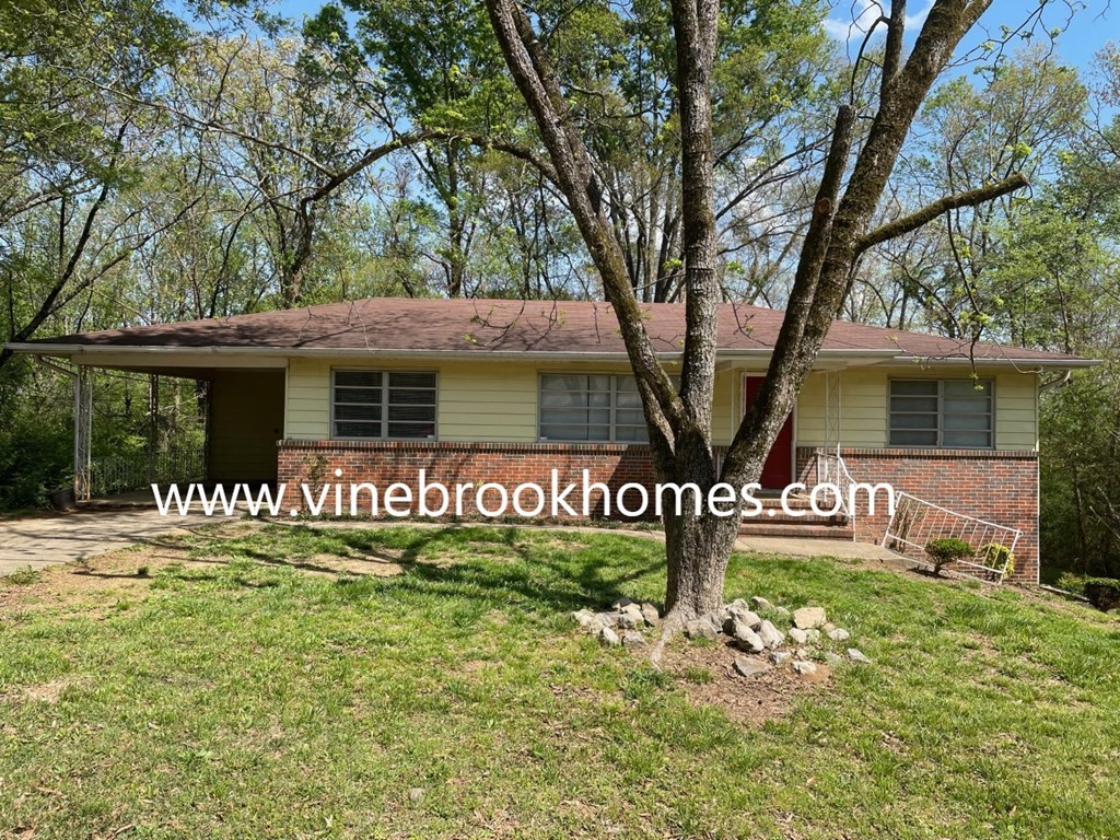 an aerial view of a house with a tree in the yard