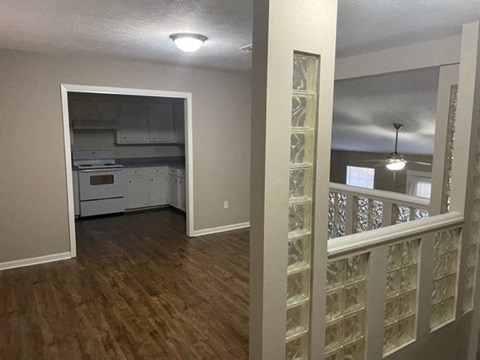 A kitchen area with a white cabinet and a fridge.