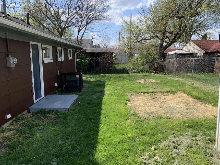 a backyard with a house and a yard with grass