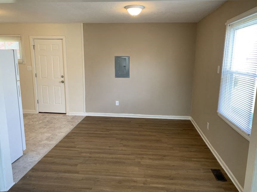 a empty room with a wooden floor and a door