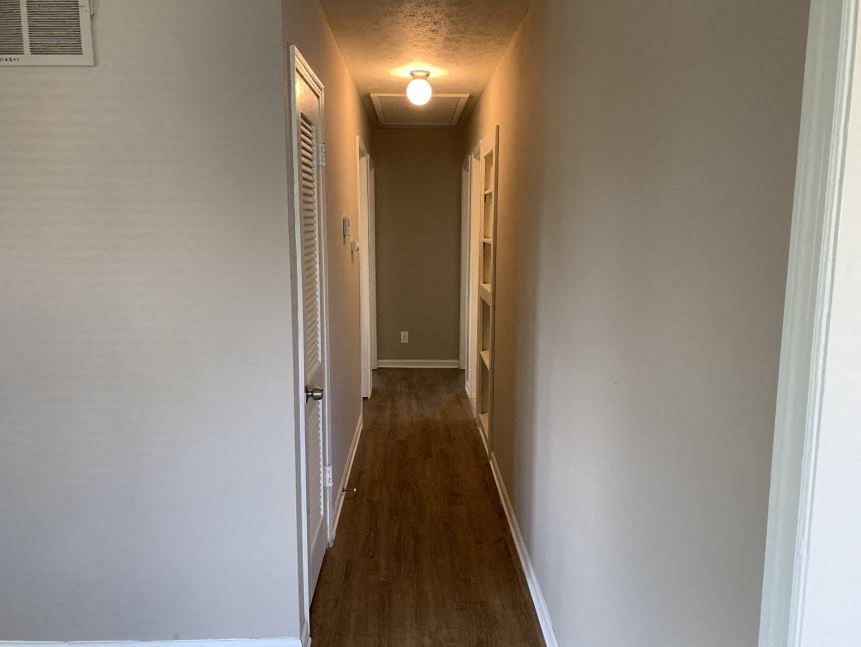 a hallway with a door and a light on the ceiling